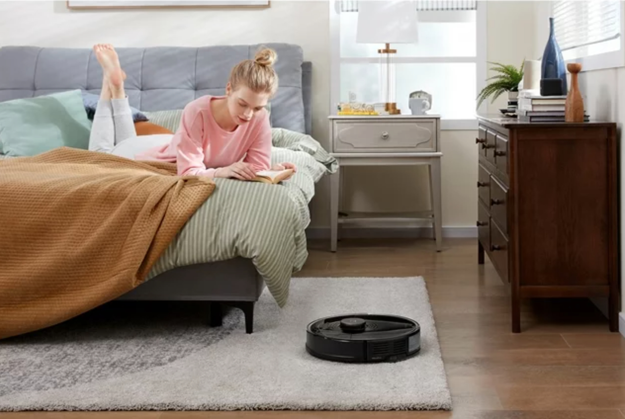a robot vacuum cleaner on the carpet of a girl&#x27;s bedroom