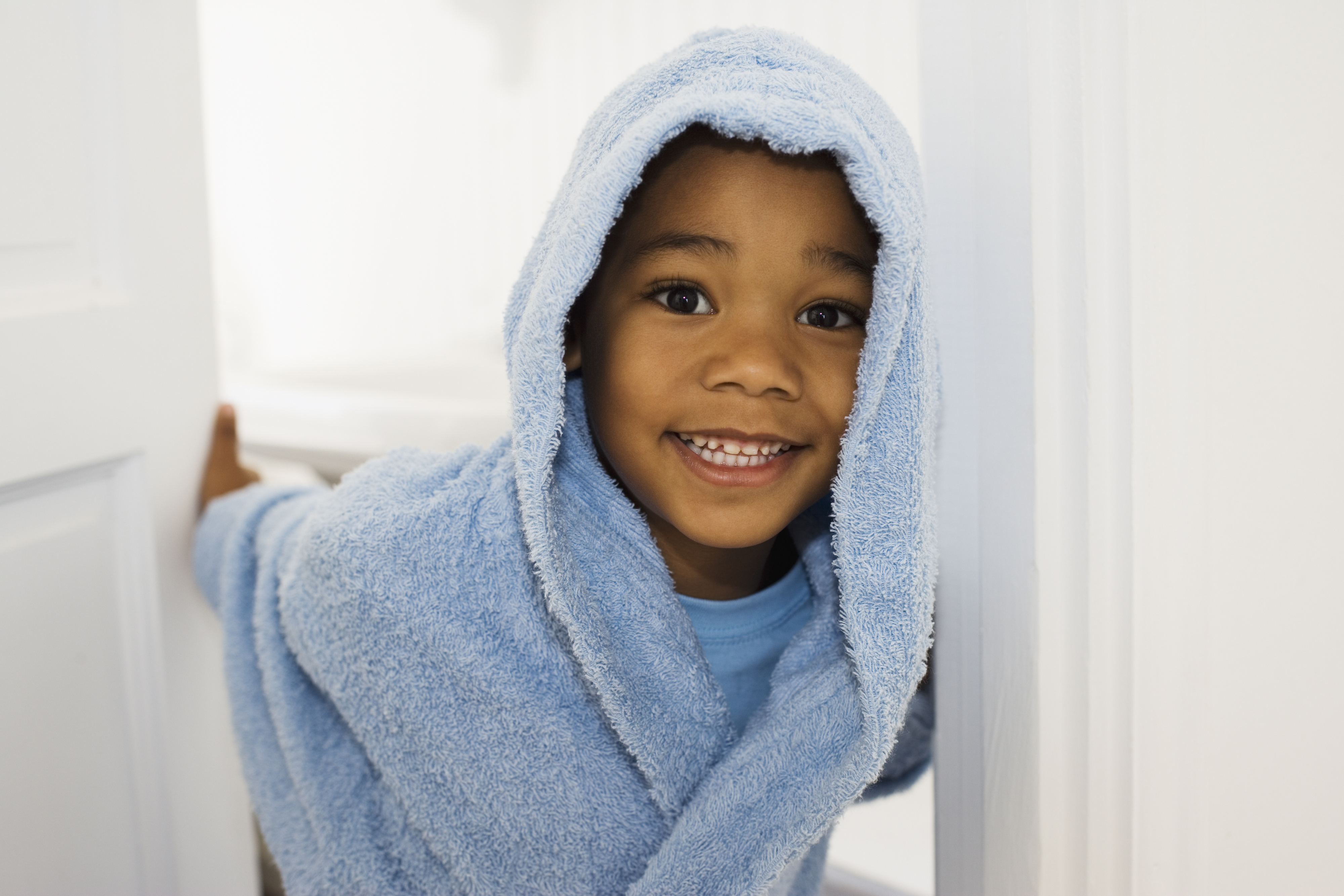 a kid in a blue bathrobe