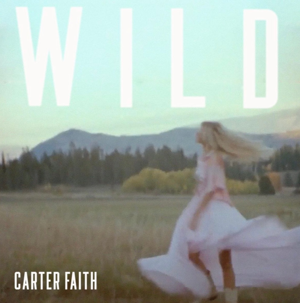 Single cover for &quot;Wild&quot; by Carter Faith, showing Carter walking in a grassy field