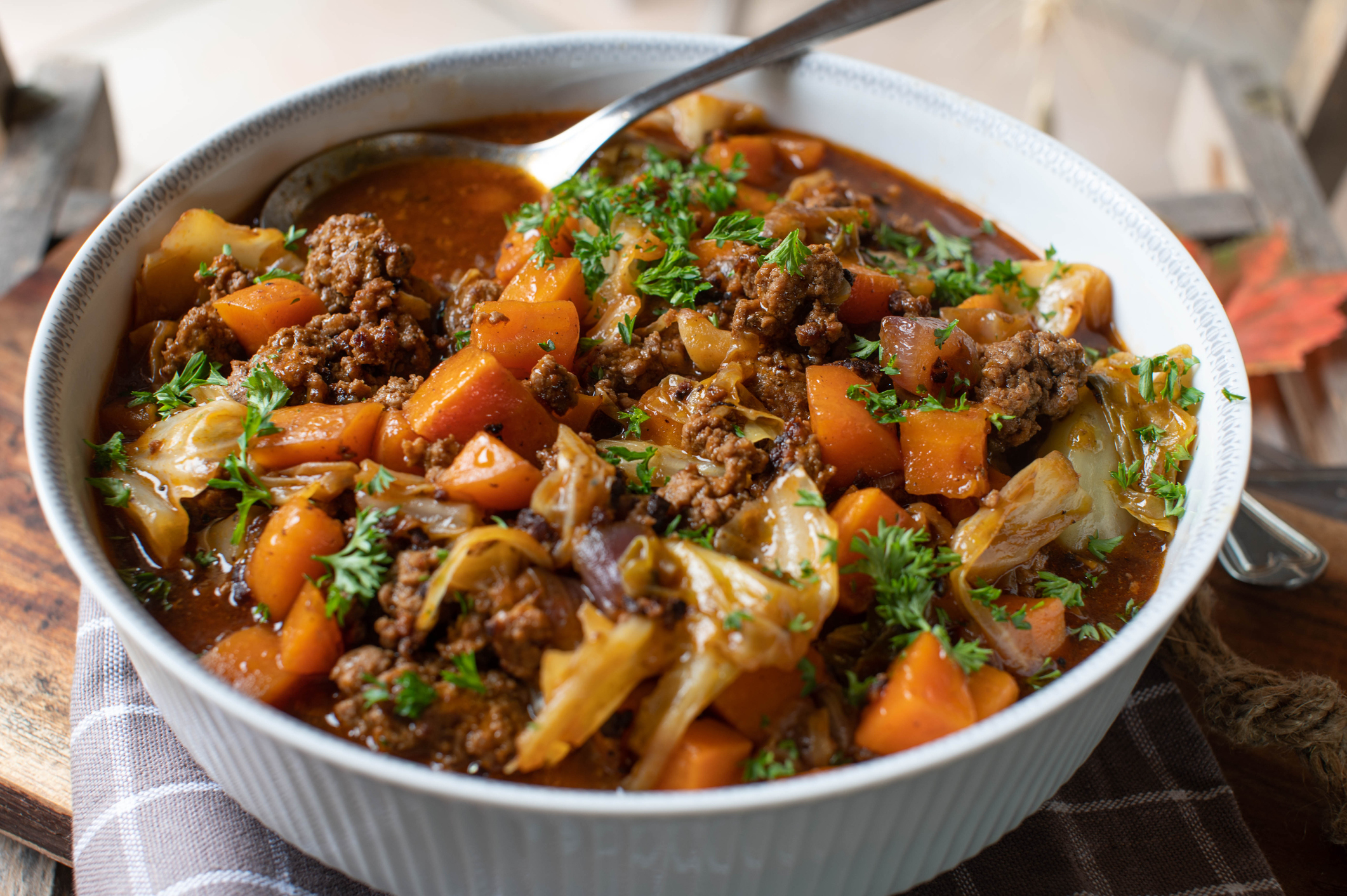 ground beef stew with cabbage, carrots, tomatoes, onions and herbs