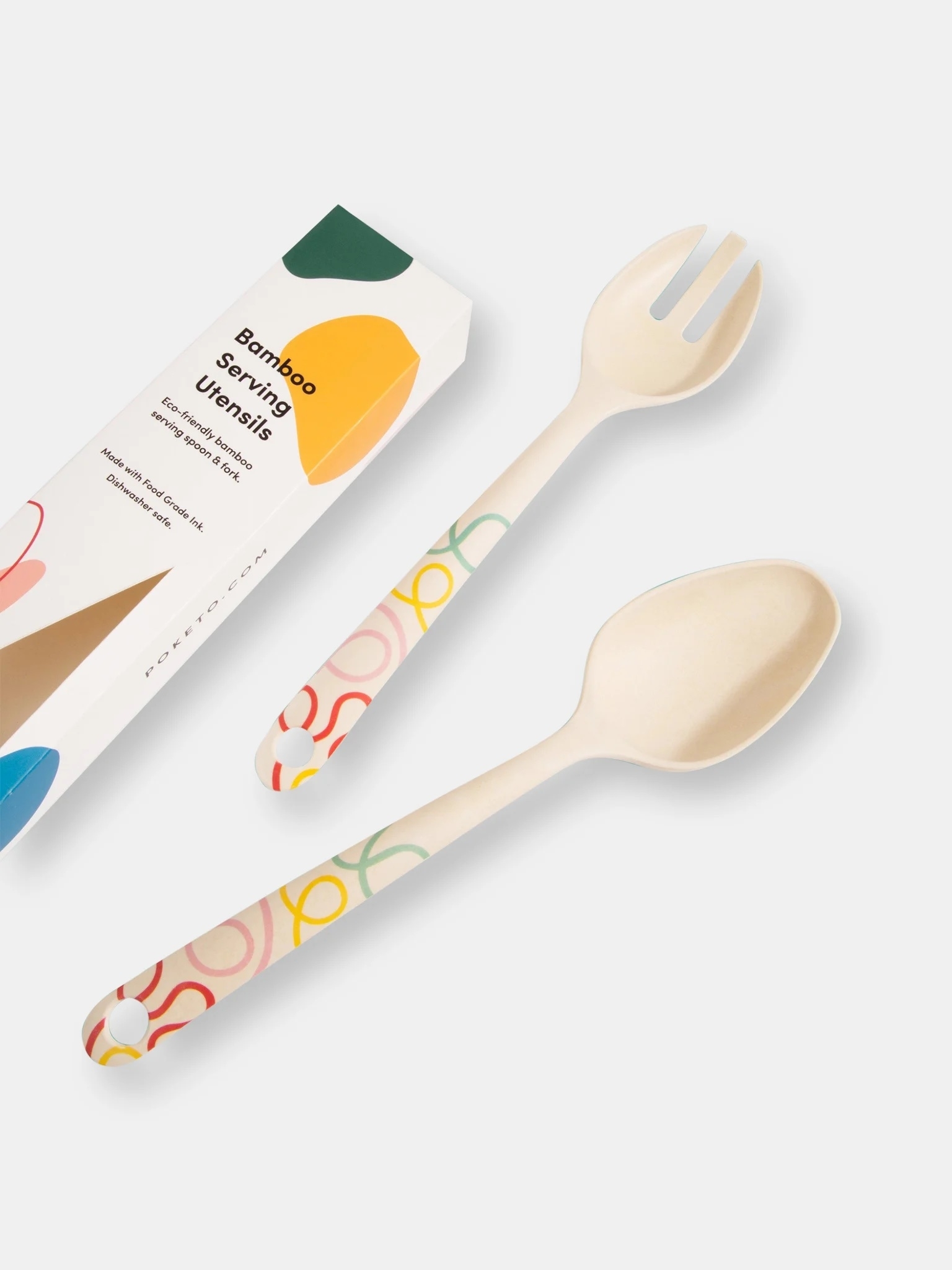 one pronged and one solid bamboo serving spoons with multicolored doodle details