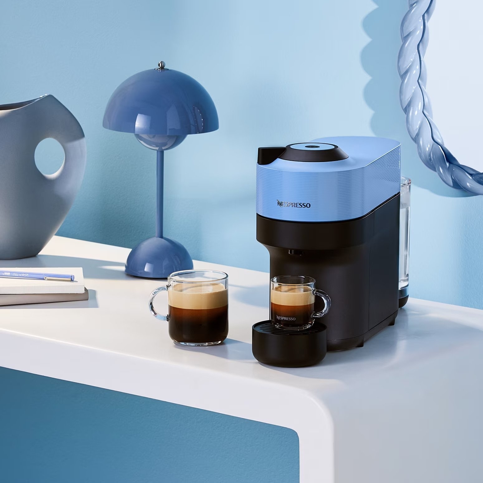 the blue and black Nespresso machine in a light blue color