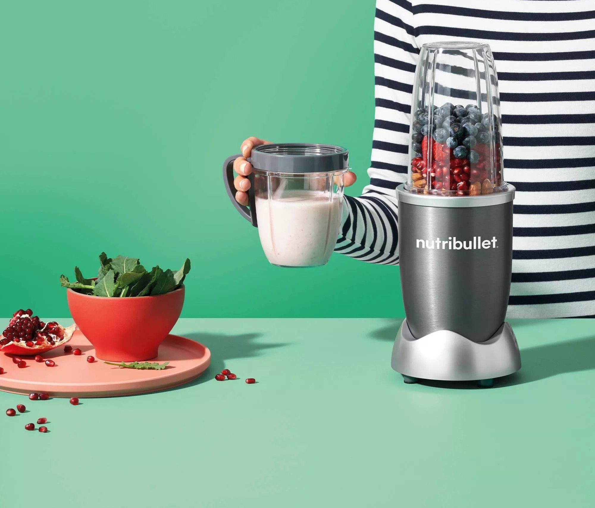 The nutribullet, featuring a short blending cup and a tall blending cup, both of which convert into travel mugs