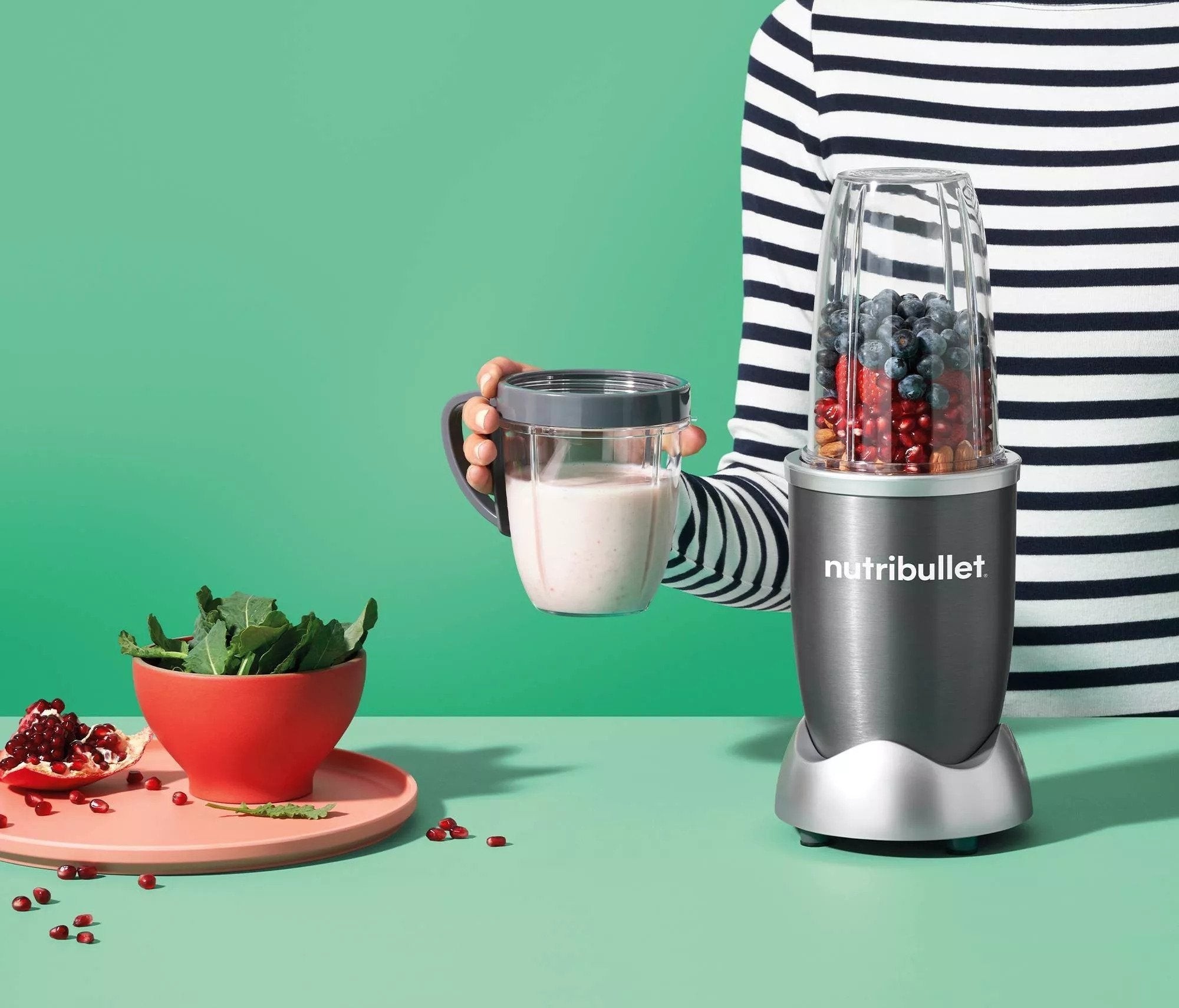 The nutribullet, featuring a short blending cup and a tall blending cup, both of which convert into travel mugs