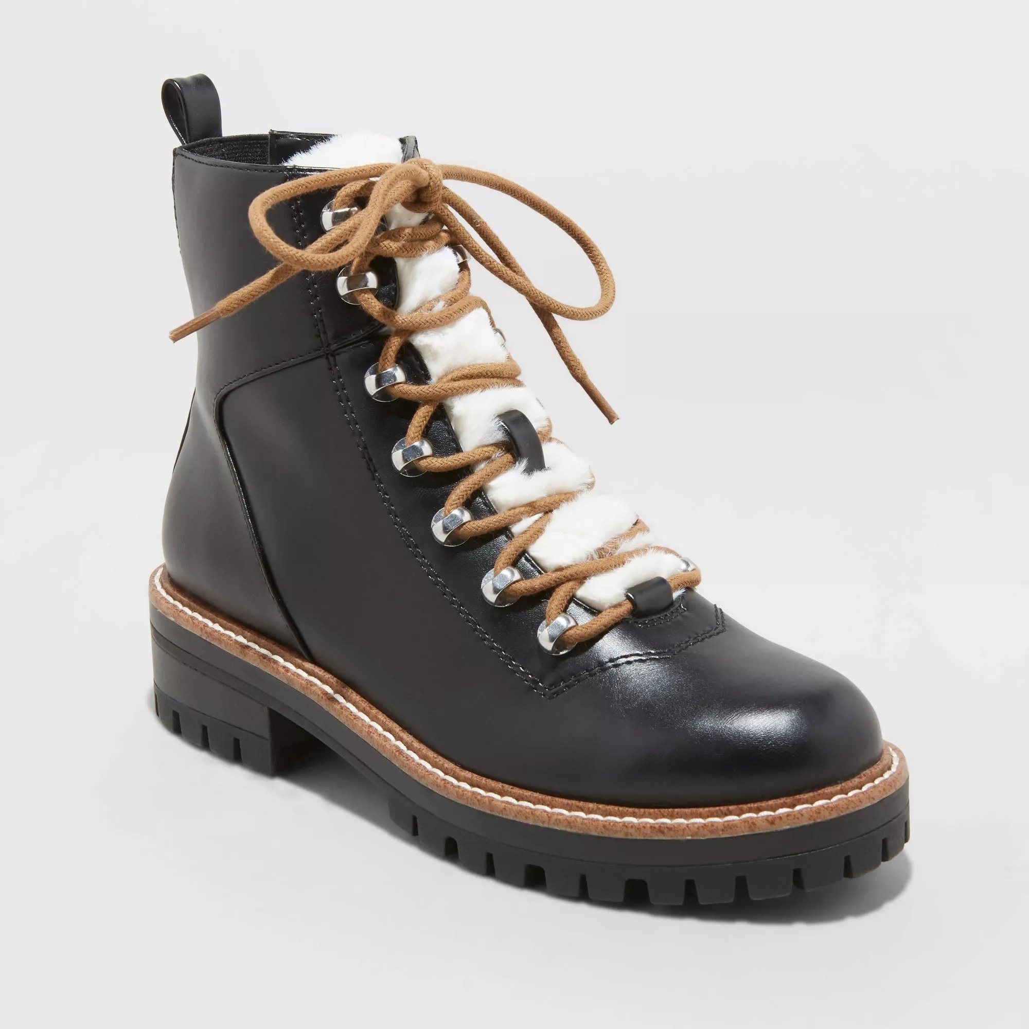 The lug sole boots in black faux leather, featuring faux-fur lining, lace-up, and side zipper closure