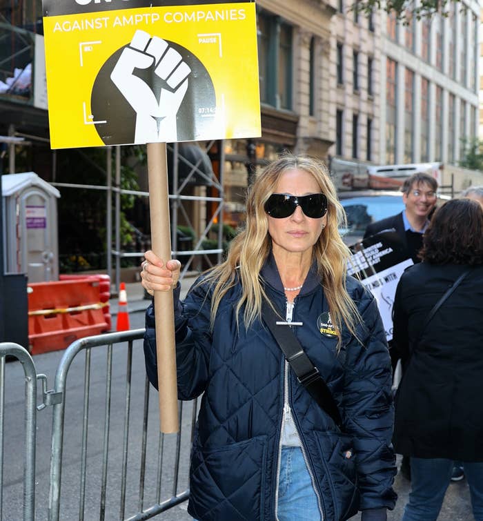 Sarah Jessica Parker holding up a picket sign