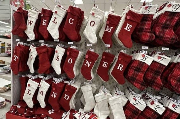 A stocking display at a store with lettered stockings rearranged to spell out "welcome to boner land"