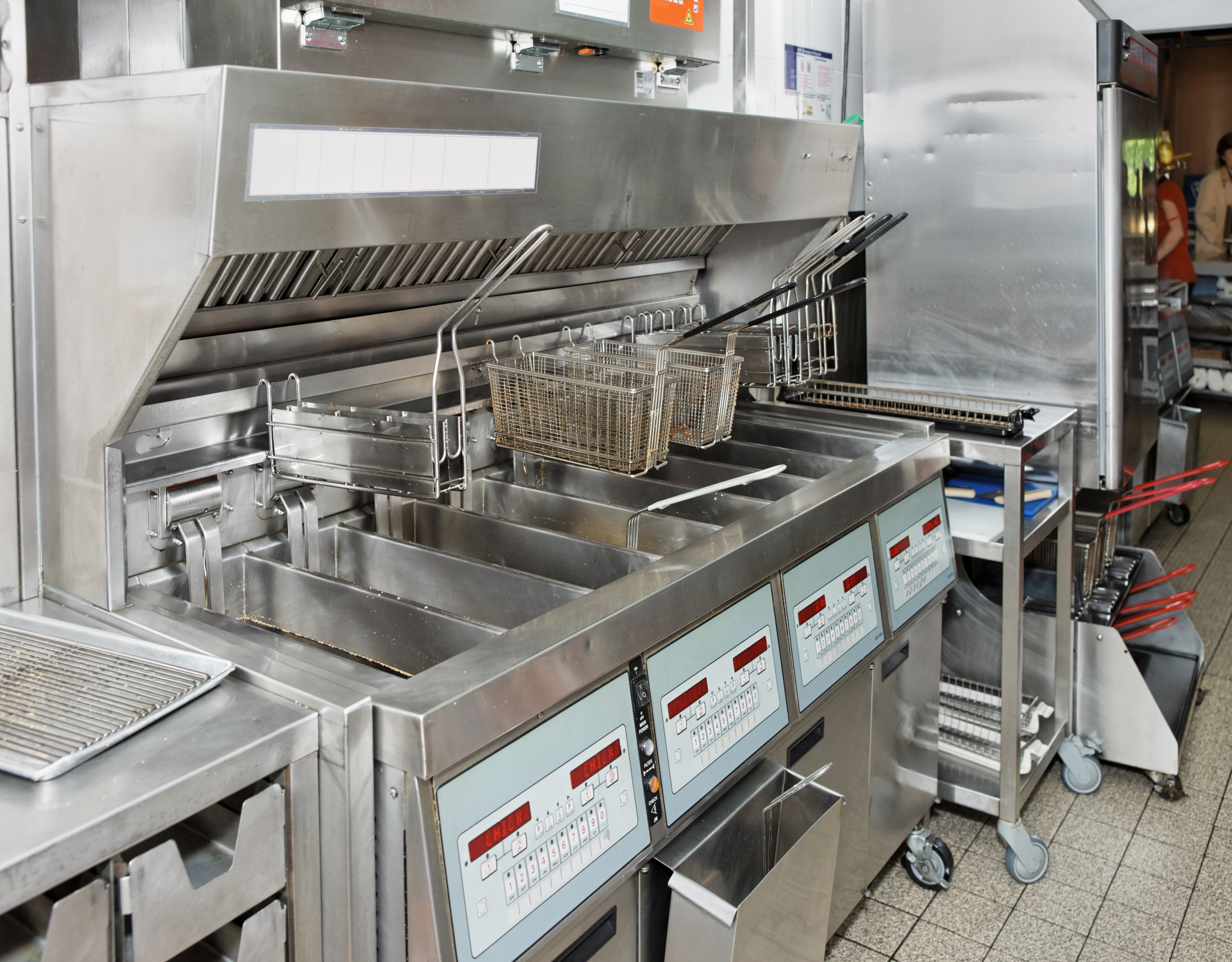 Deep friers with oil in the back of a fast-food restaurant