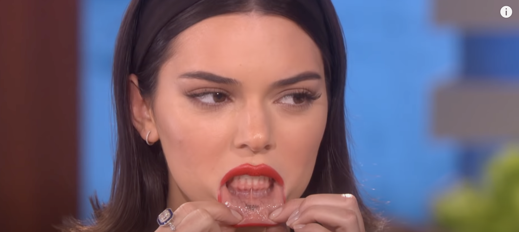 Close-up of Kendall showing her lip tattoo