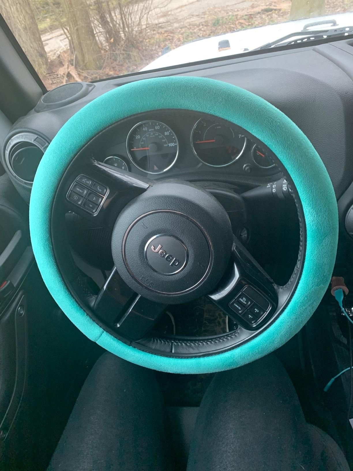 blue memory foam steering wheel cover on car wheel
