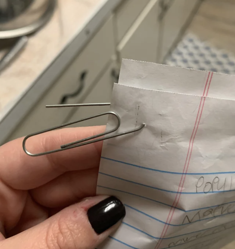 a paper clip stuck through a page
