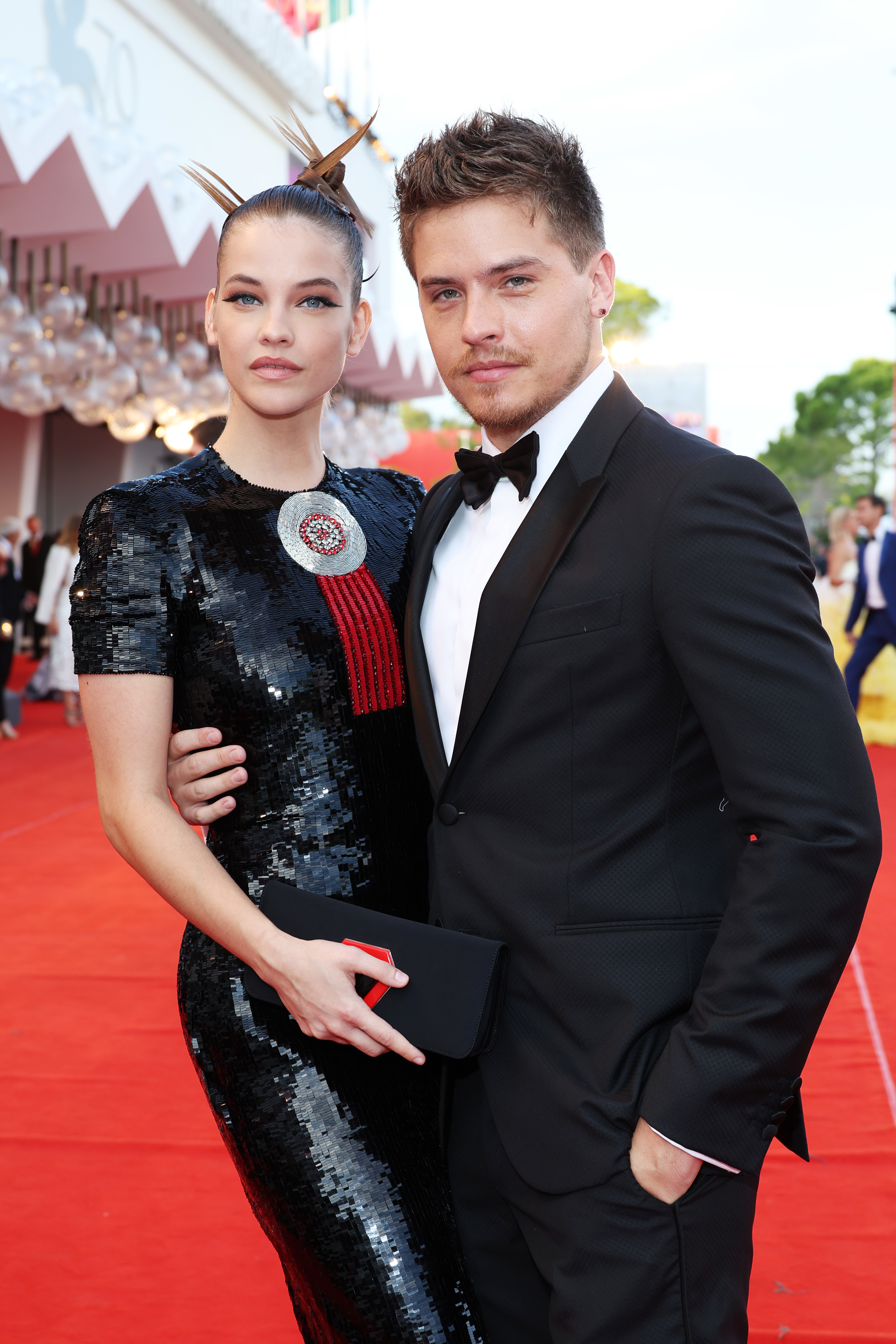 closeup of his arm around her as they pose on the red carpet