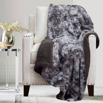 the blanket in gray t draped over a chair