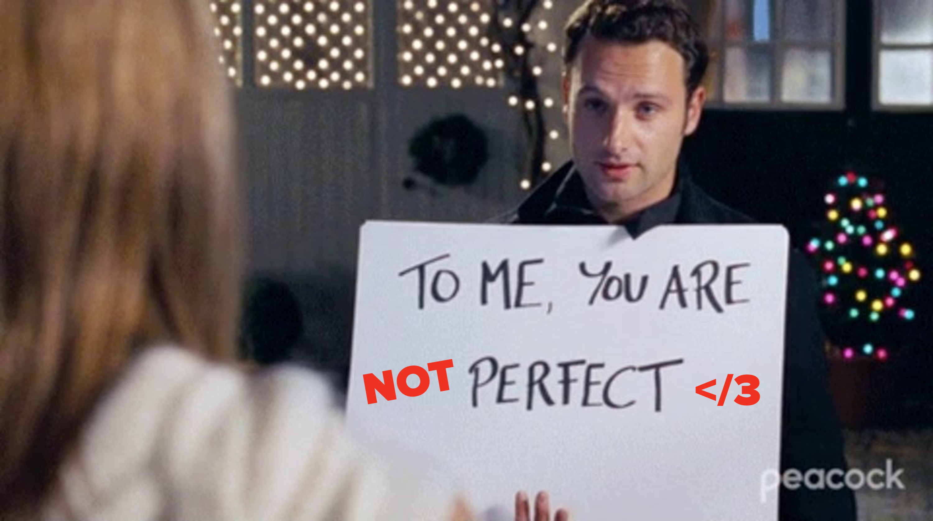 guy holding a sign that&#x27;s been edited to say to me you are not perfect