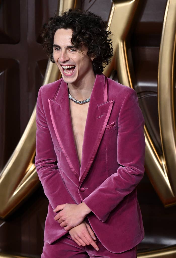 Timothée in a velvet suit laughing