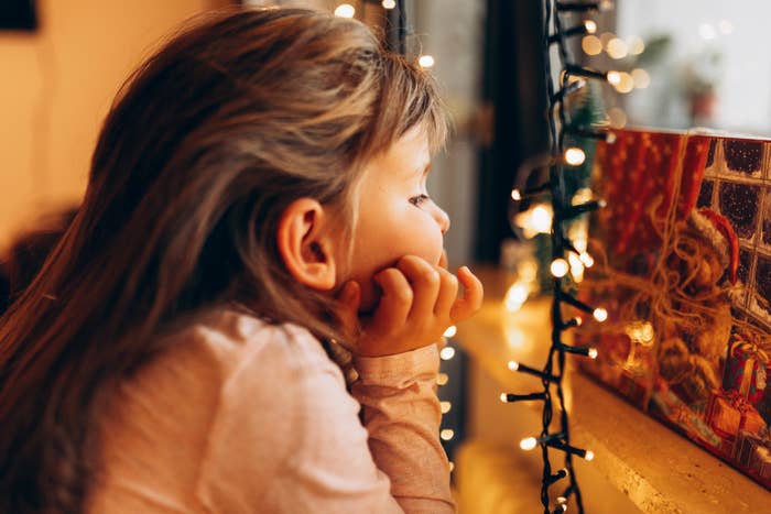 a little girl looking at Christmas decorations