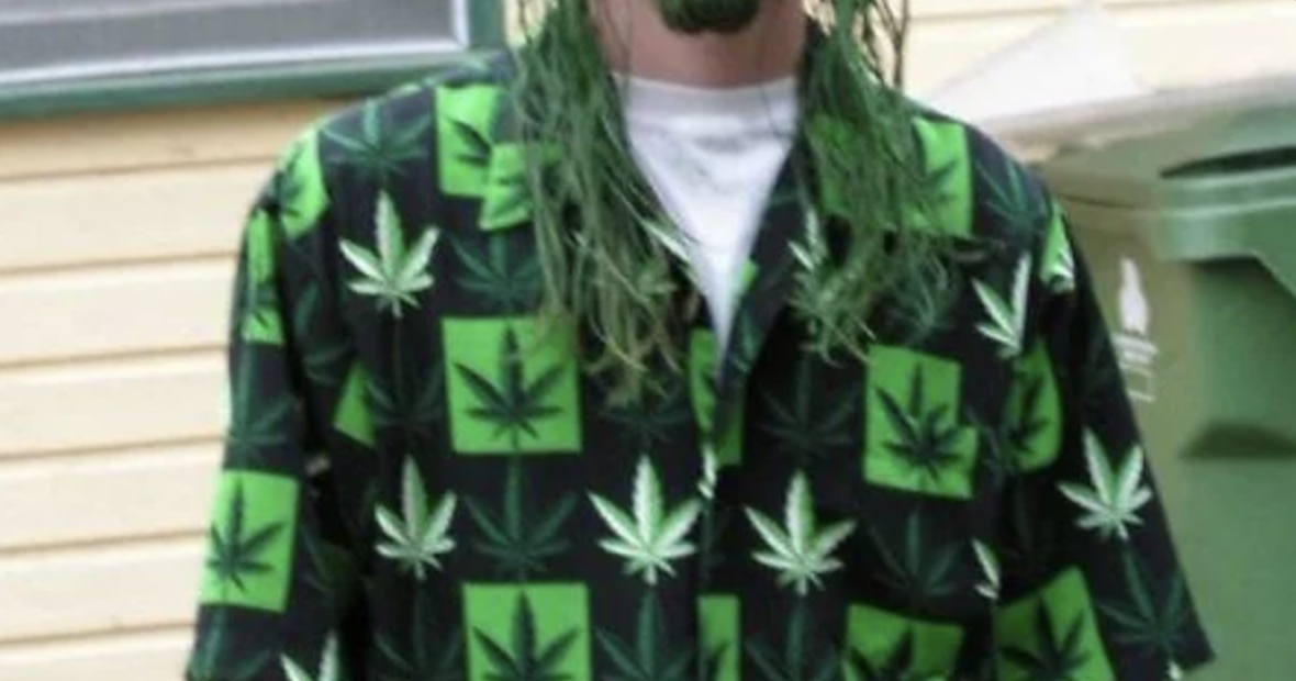 a man wearing a weed shirt