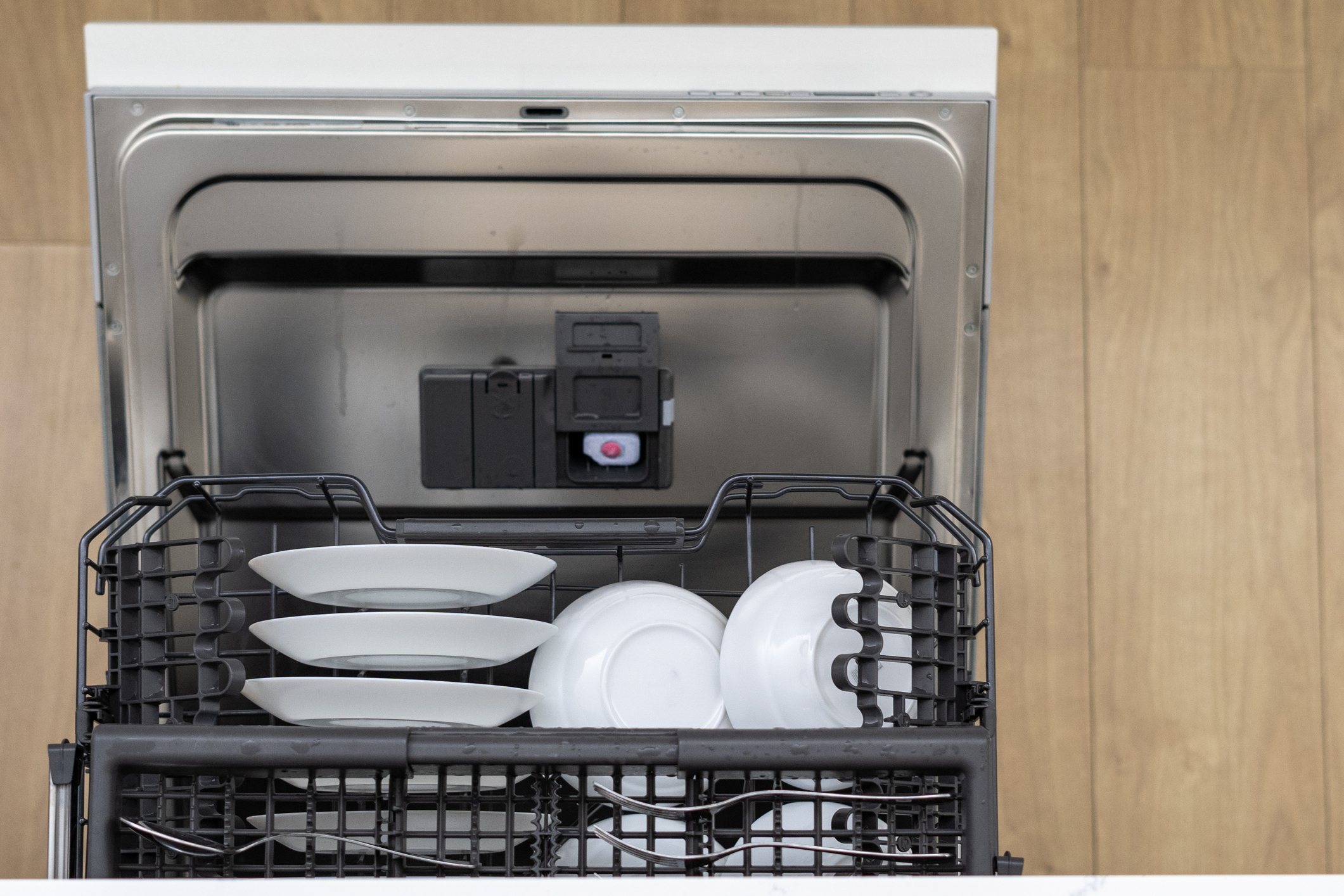 a dishwasher loaded with plates and bowls