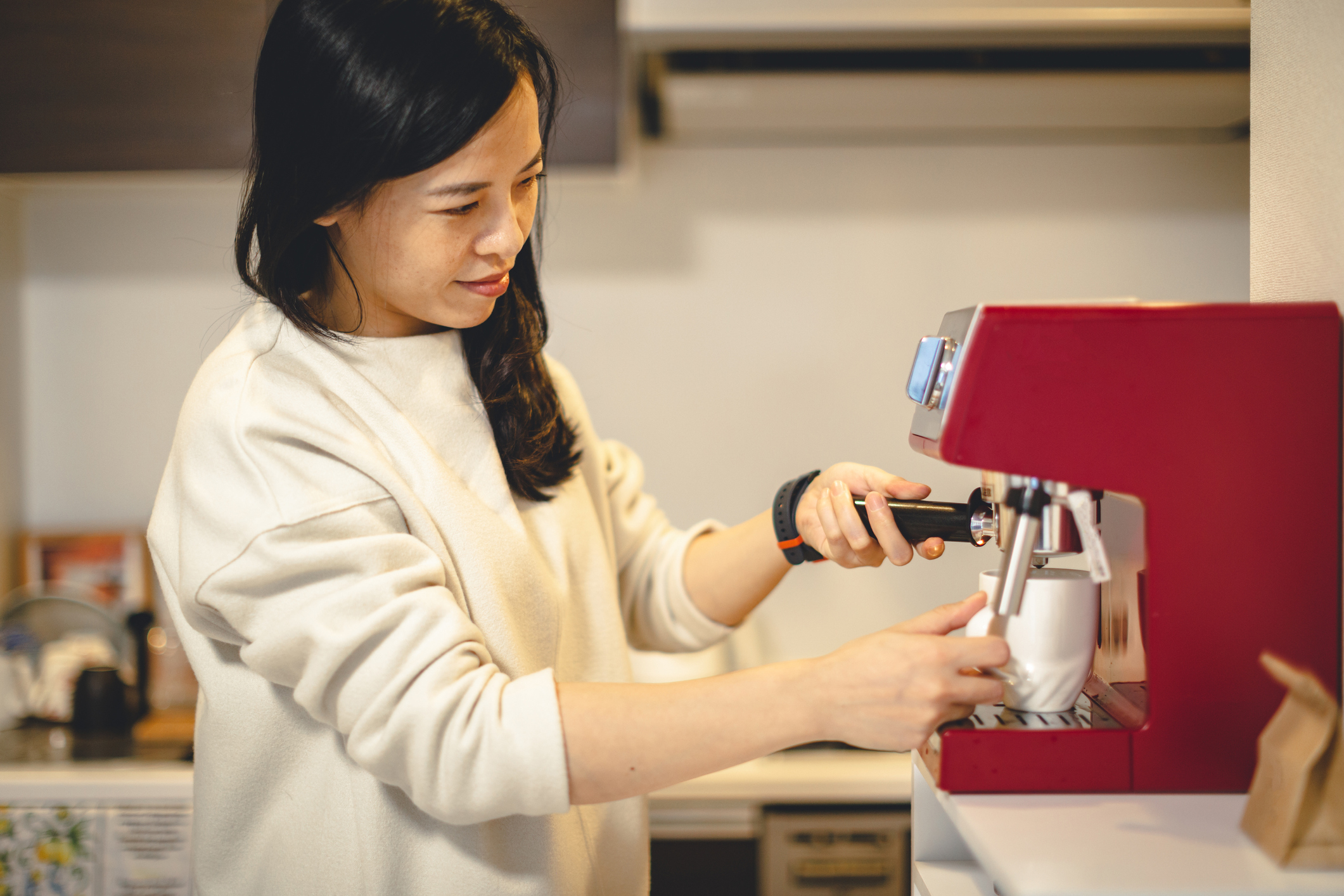 a woman making an espresso