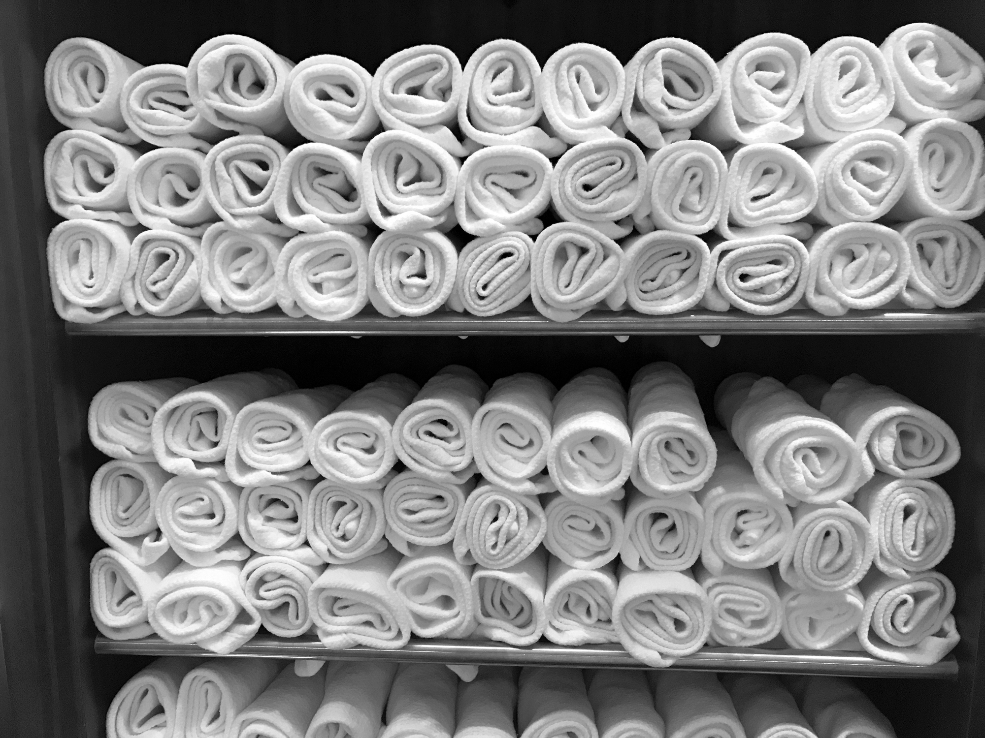 Towels are rolled up on shelves