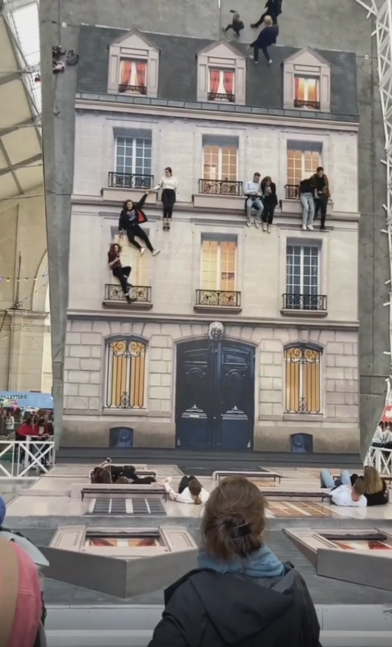 people laying on the floor to make it looks like their on a buidling