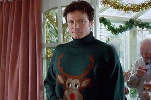 Colin Firth frowning while wearing a Rudolph sweater as Mark in Bridget Jones's Diary