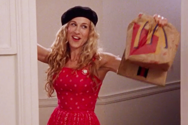 Carrie Bradshaw from Sex and the City wearing a beret and holding McDonald's bags