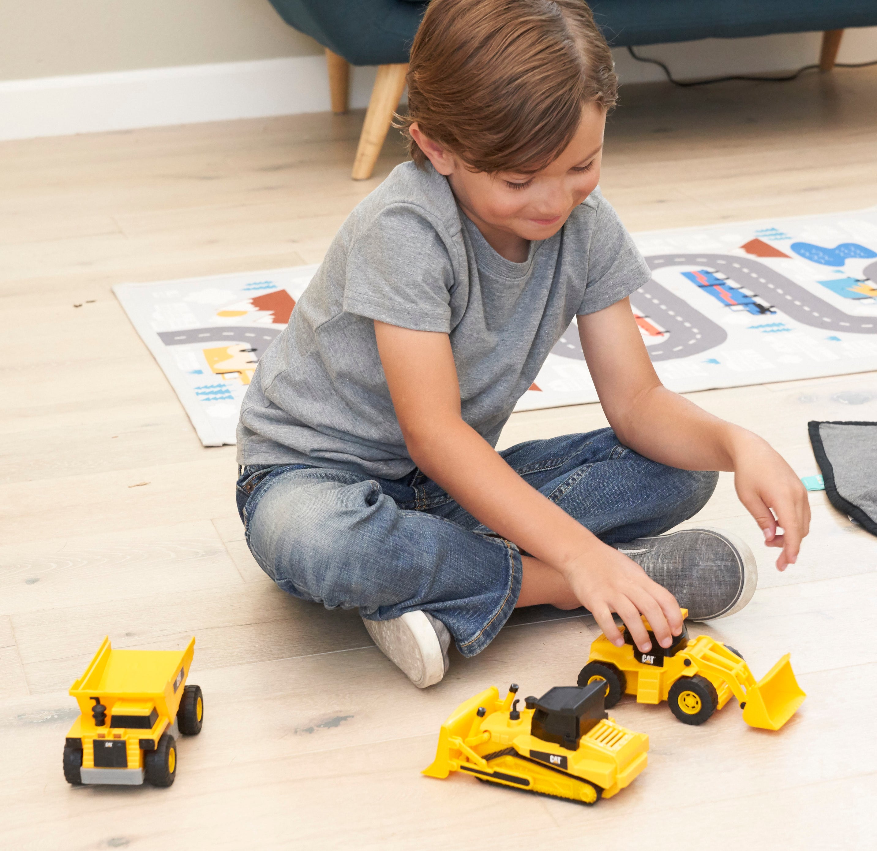 a child playing with the mini crew construction vehicles