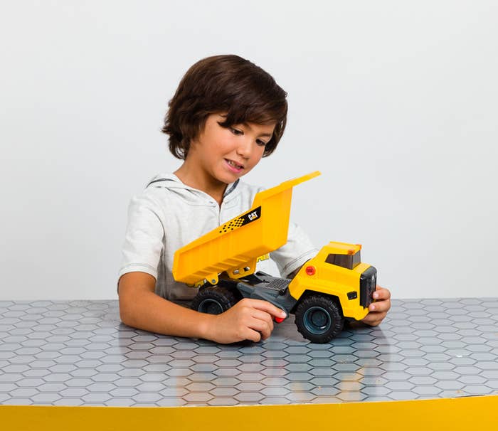 a child playing with the power hauler dump truck