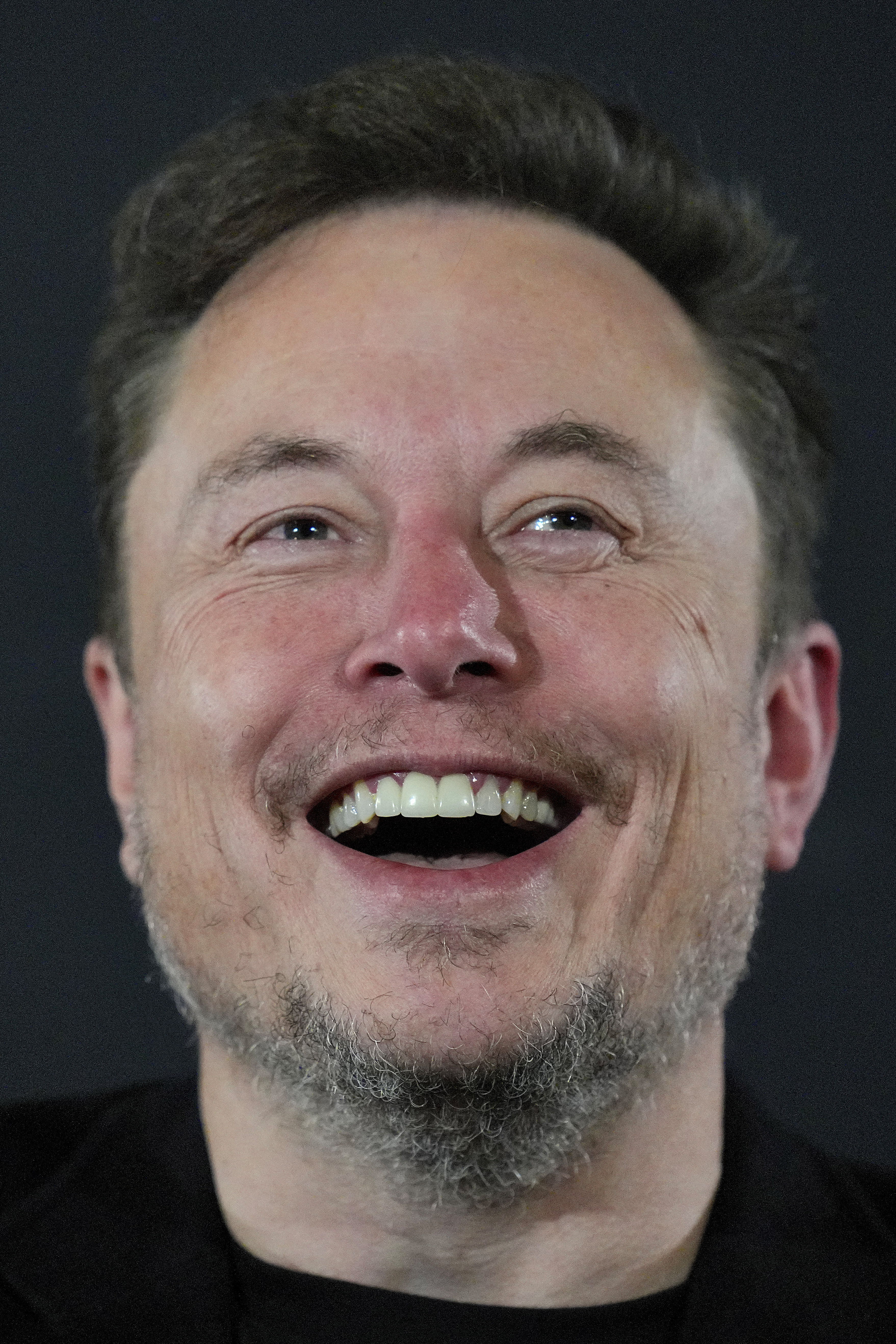 Closeup of Elon Musk smiling widely
