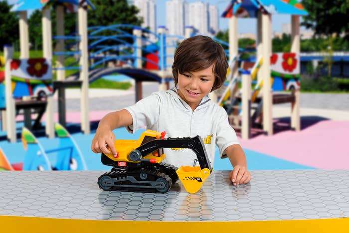 a child playing with the excavator