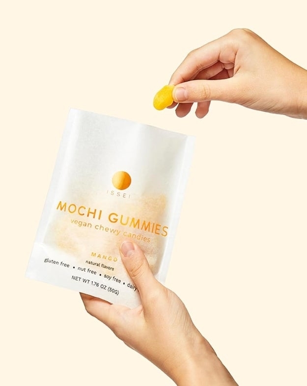 Model holding mochi gummies packet