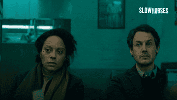 Gif of two people leaning their heads together and looking at something
