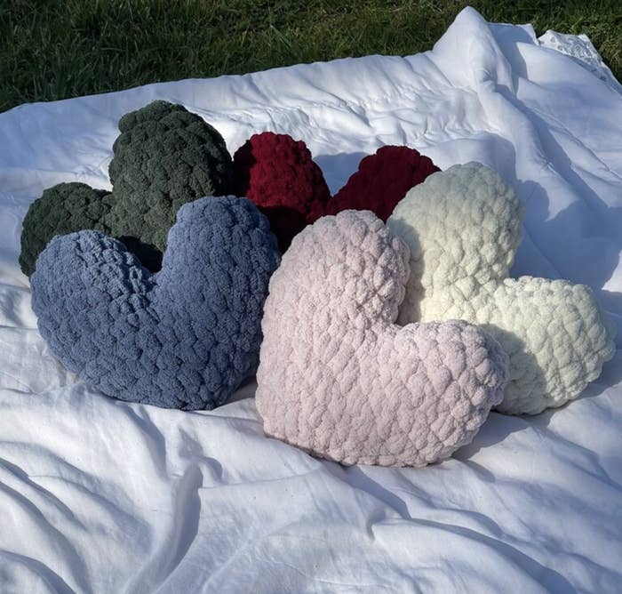 Crocheted hearts on picnic blanket;
