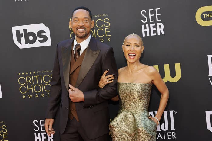 Close-up of Will and Jada smiling and arm in arm on the red carpet
