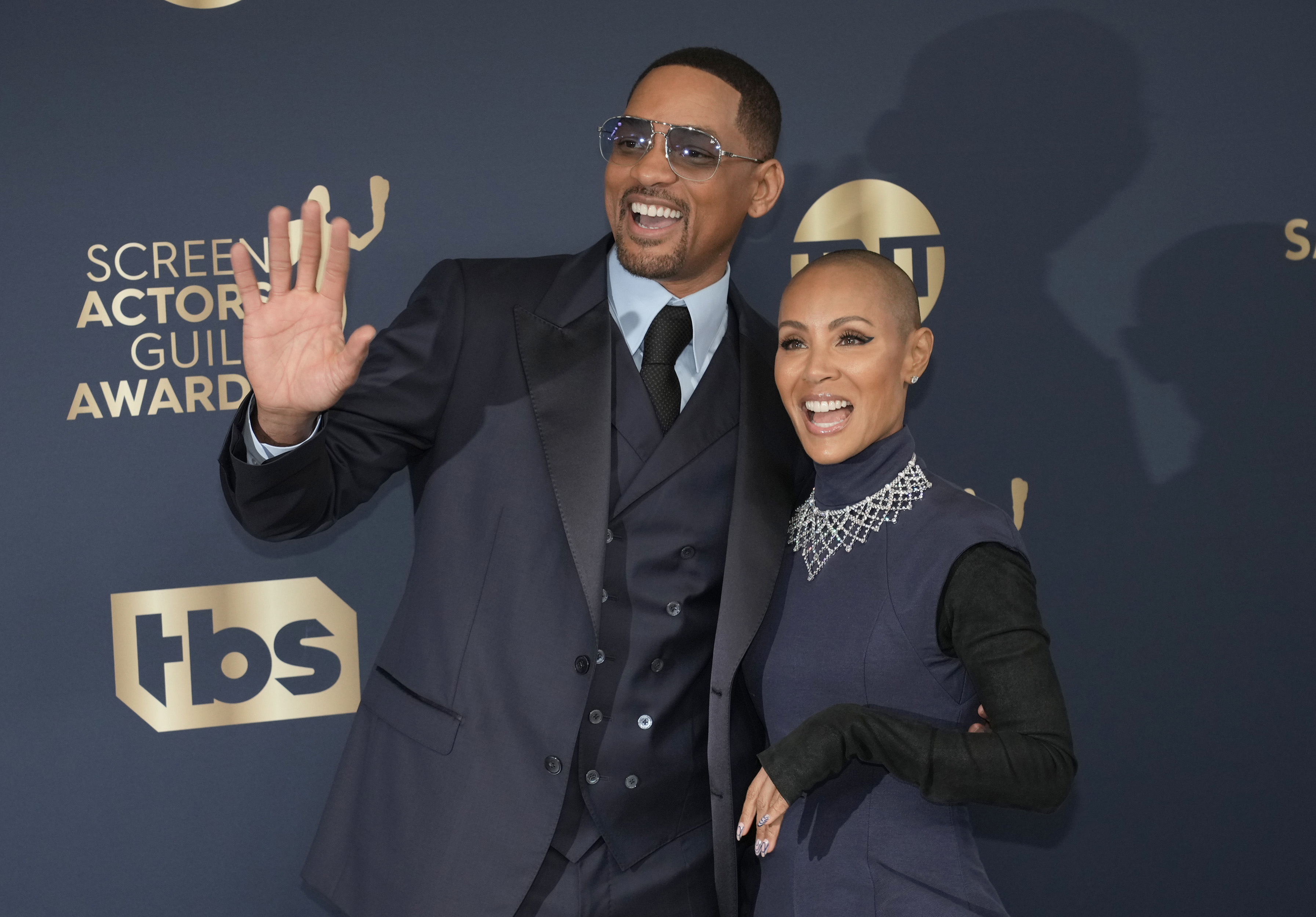 Close-up of Will and Jada smiling and waving at a media event