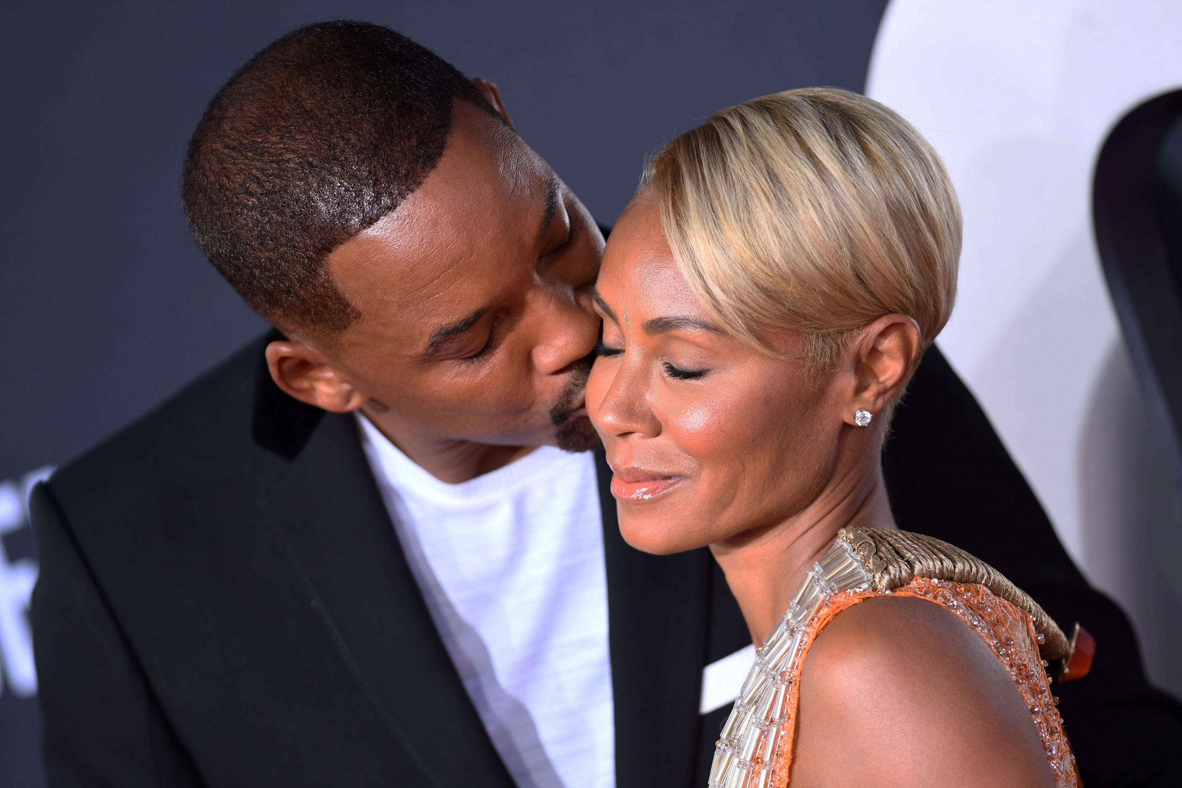 Close-up of Will kissing Jada on the cheek
