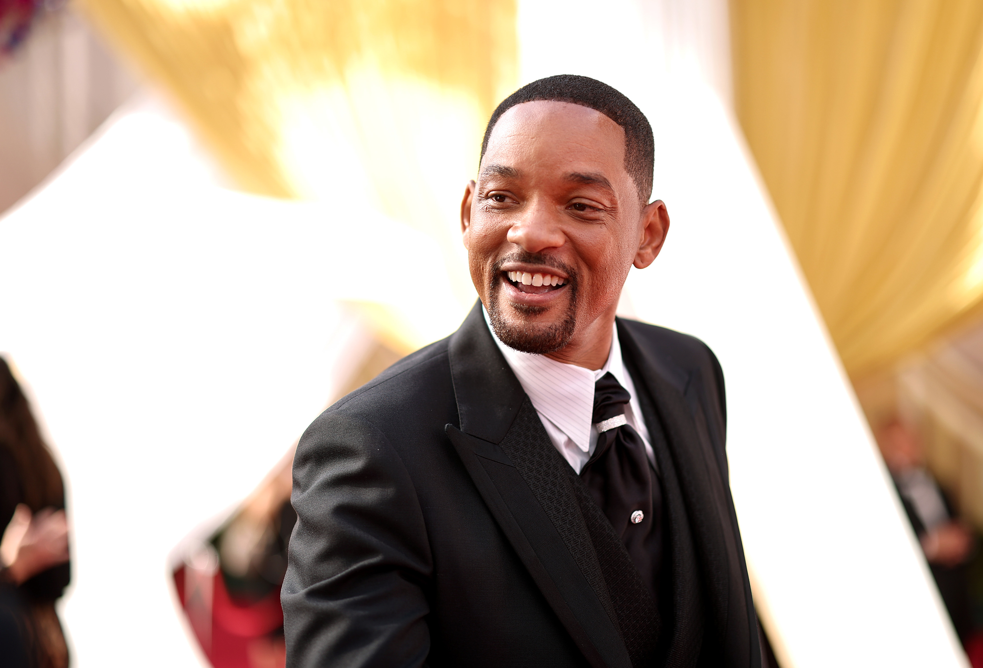 Close-up of Will smiling in a suit and tie