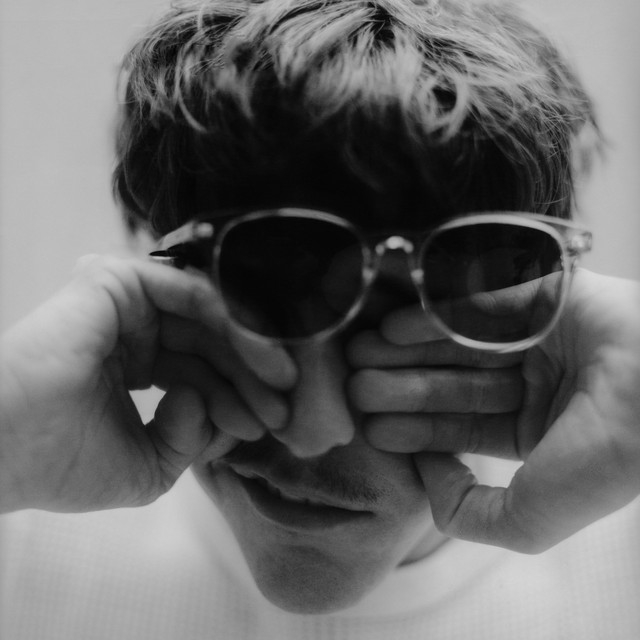 Single cover for &quot;A Little More Time&quot; by Role Model, showing Role Model rubbing his eyes behind sunglasses