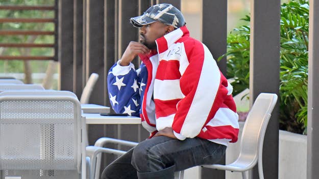 ye at a table wearing a flag jacket