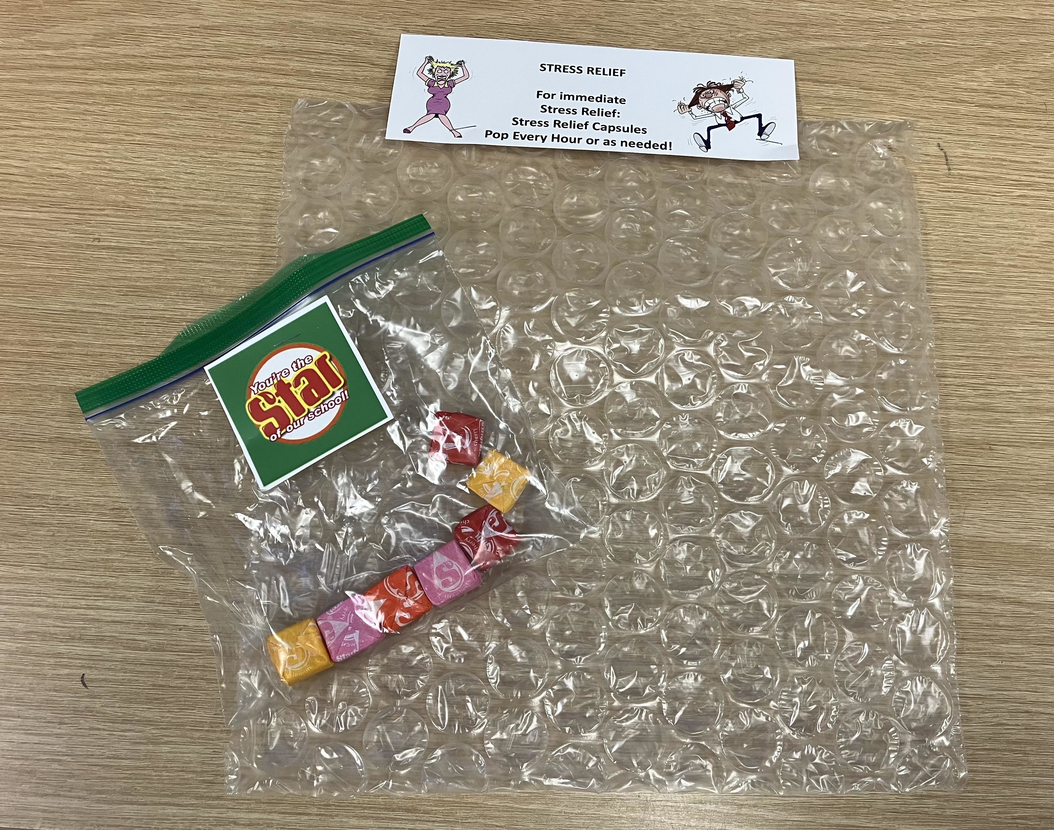 Seven candies in a baggie next to some bubble wrap "for immediate stress relief," according to a note
