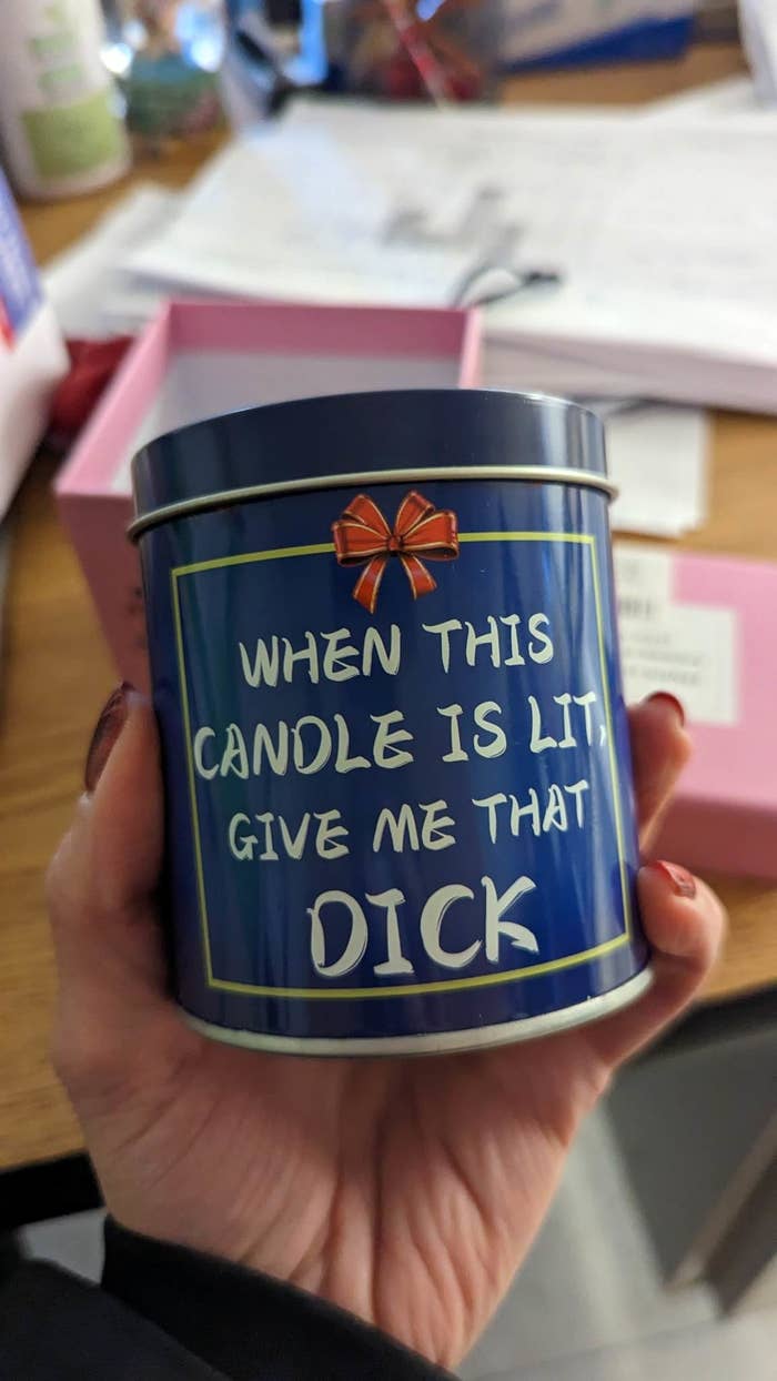 Person holding a candle tin that says &quot;When this candle is lit, give me that dick&quot;