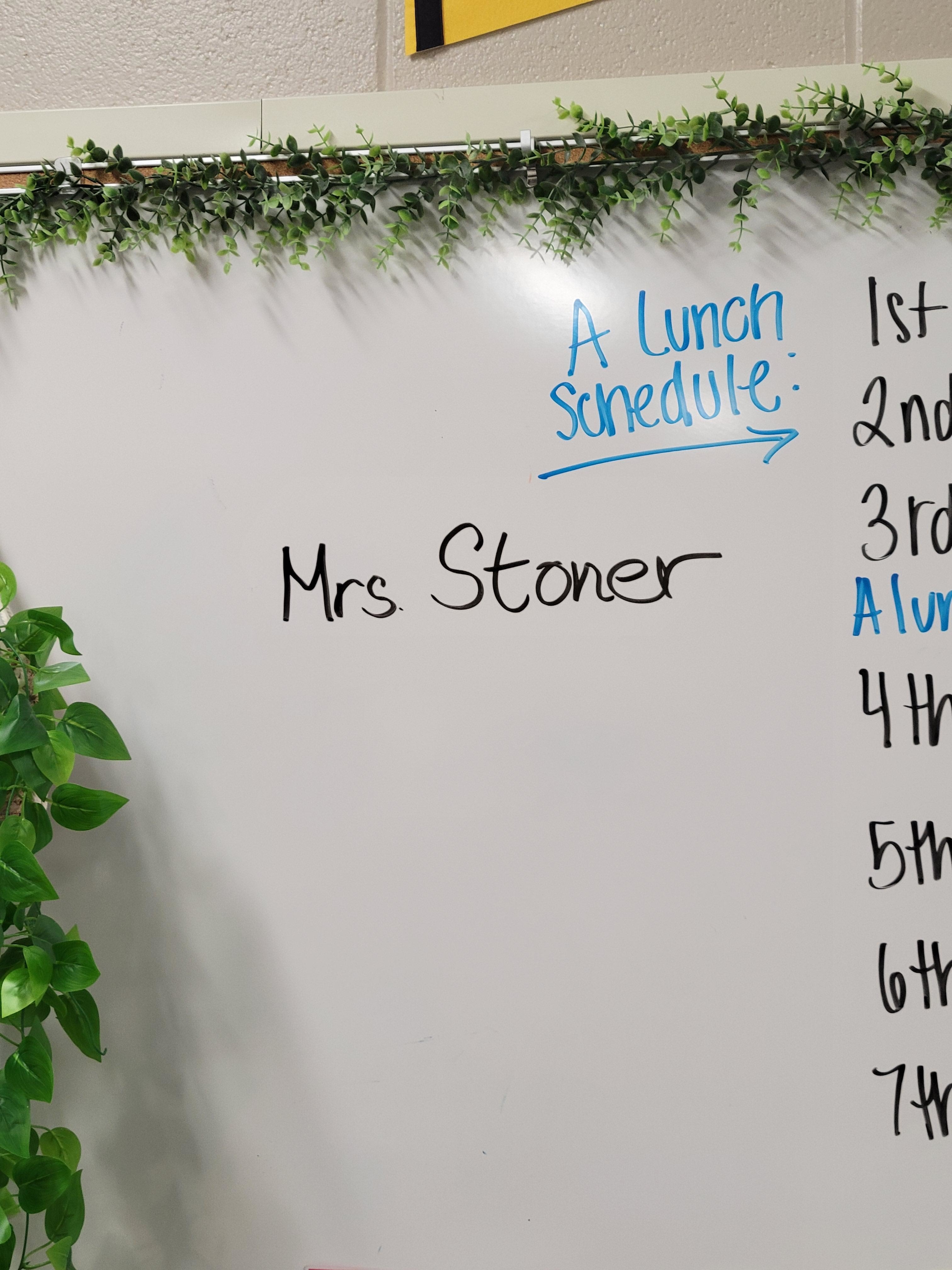 The teacher&#x27;s name, &quot;Mrs Stoner,&quot; written on a whiteboard, along with a lunch schedule