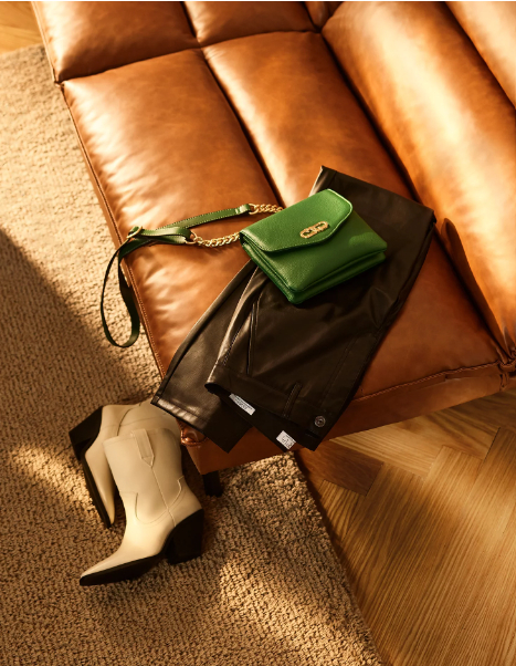 crossbody bag in green on couch