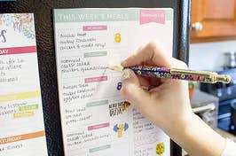 model filling out a meal-tracking notepad