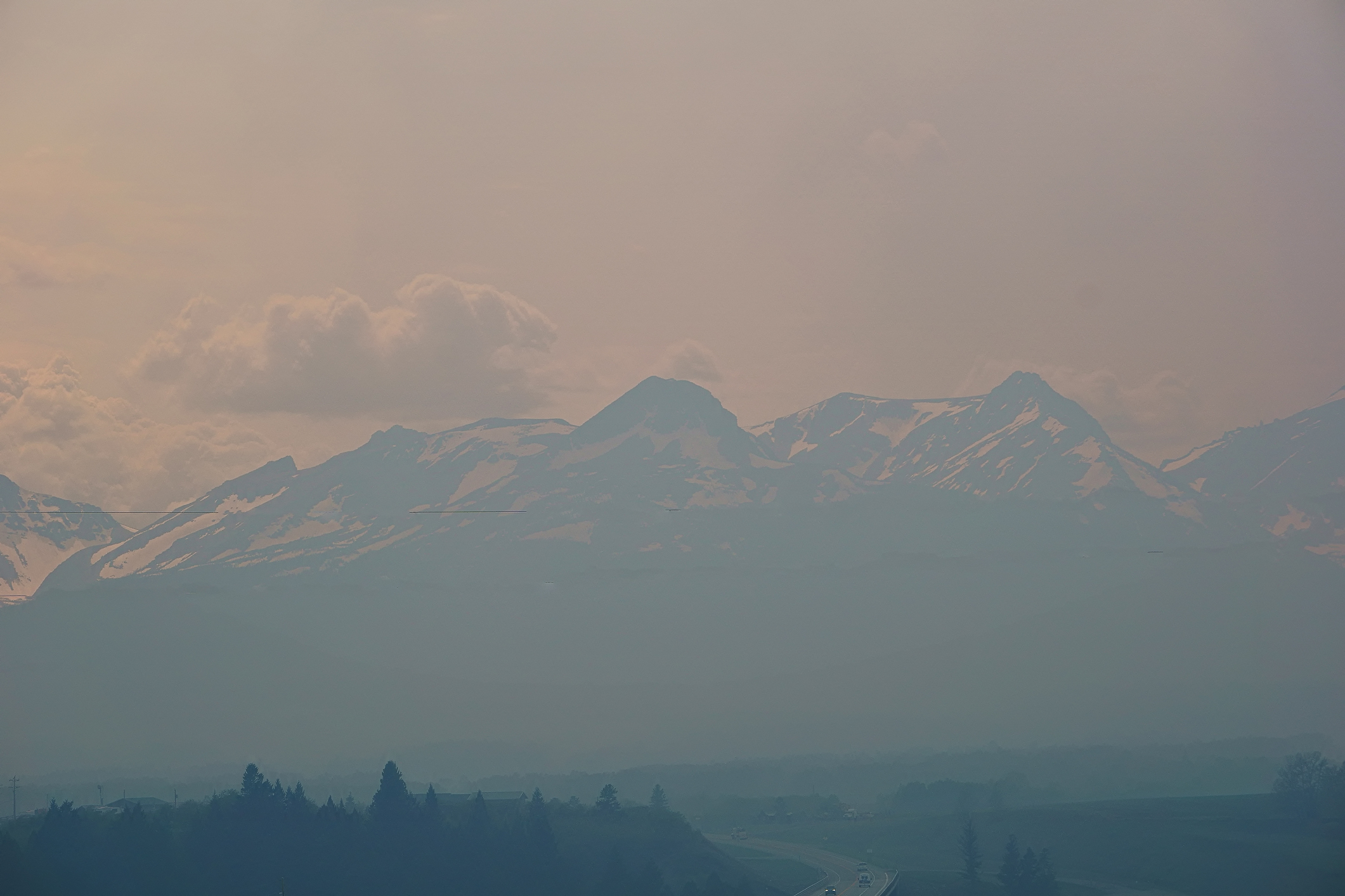 Dancing Woman Mountain and its neighboring peaks are nearly obliterated by smoke drifting in from Canadian wildfires