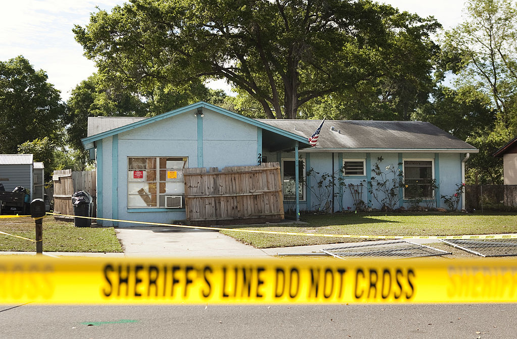 a house with sheriff&#x27;s tape in front of it