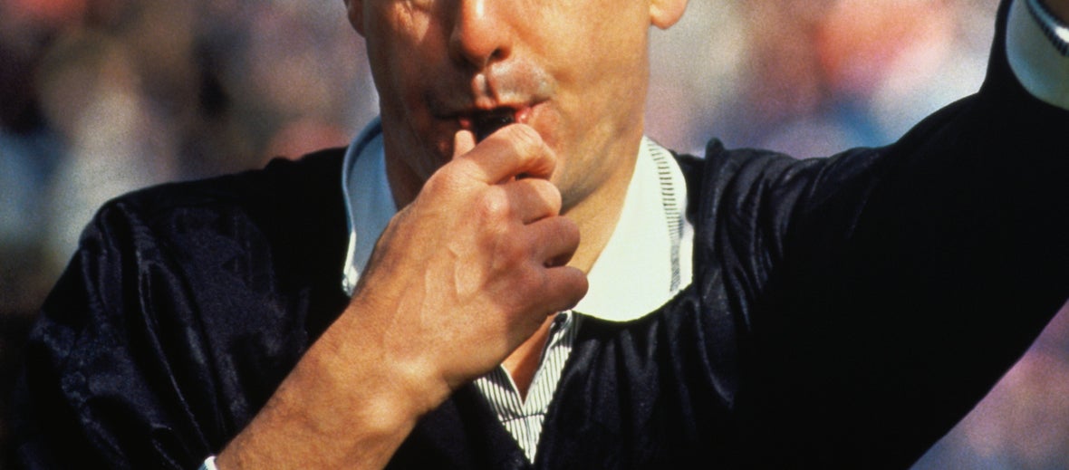 a referee blowing a whistle