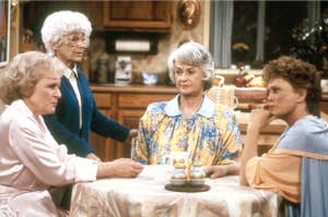 Betty White, Estelle Getty, Bea Arthur, and Rue McClanahan sitting around a table.