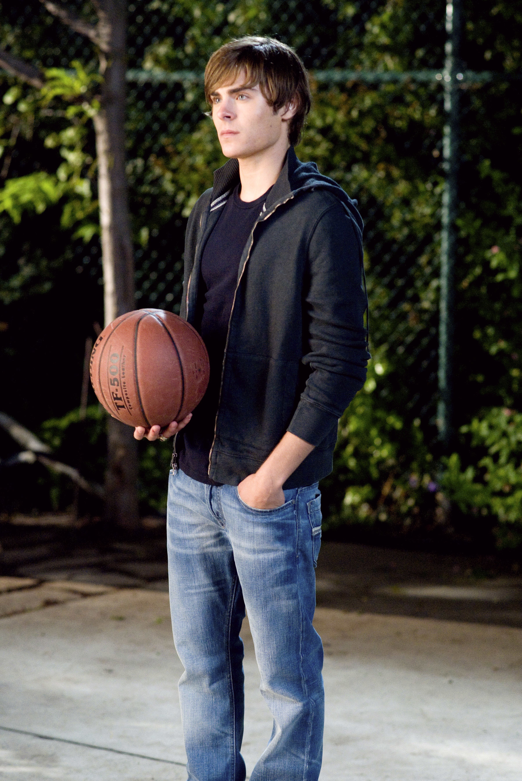 Zac holding a basketball in a scene from &quot;High School Musical&quot;